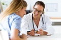 Female doctor prescribing medication for patient. Royalty Free Stock Photo