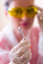 Female doctor in protective glasses and rubber gloves holding open insulin syringe Royalty Free Stock Photo