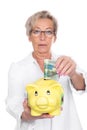 Female doctor with piggy bank Royalty Free Stock Photo