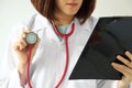 Female doctor reading a patient treatment chart. Royalty Free Stock Photo