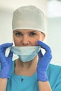 Portrait of female doctor removing surgical mask at clinic