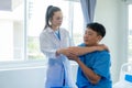 Female doctor's hand doing physiotherapy stretching the shoulder of a male patient. Royalty Free Stock Photo