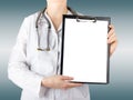 Female doctor's hand holding blank medical clipboard and stethos