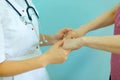 Female doctor`s hands holding patient`s hand for encouragement and empathy. Partnership, trust and medical ethics concept. Royalty Free Stock Photo