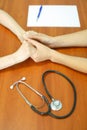 Female doctor`s hands holding patient`s hand for encouragement and empathy. Partnership, trust and medical ethics concept. Royalty Free Stock Photo