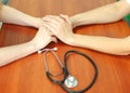 Female doctor`s hands holding patient`s hand for encouragement and empathy. Partnership, trust and medical ethics concept. Royalty Free Stock Photo