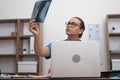 female doctor scrutinizes patient X-ray scan, concurrently checking test results on her laptop Royalty Free Stock Photo