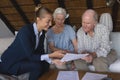 Female doctor and senior couple discussing over medical reports Royalty Free Stock Photo