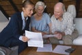 Female doctor and senior couple discussing over medical reports Royalty Free Stock Photo