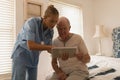 Female doctor and senior man using digital tablet Royalty Free Stock Photo