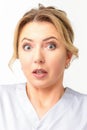 Female doctor shocked. Close up portrait of a young caucasian woman looking surprised with wide eyes stared isolated