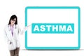 Female doctor showing asthma word on a board