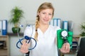 female doctor showing stethoscope and blood meassuring tool