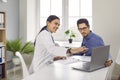 Female doctor showing test results to patient on laptop computer Royalty Free Stock Photo