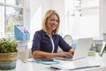 Female Doctor Sitting At Desk Working At Laptop In Office Royalty Free Stock Photo