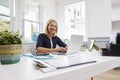 Female Doctor Sitting At Desk Working At Laptop In Office Royalty Free Stock Photo