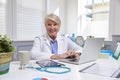 Female Doctor Sitting At Desk Working At Laptop In Office Royalty Free Stock Photo