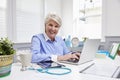 Female Doctor Sitting At Desk Working At Laptop In Office Royalty Free Stock Photo