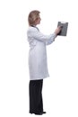 Female doctor smiling and showing a clipboard with an empty document Royalty Free Stock Photo