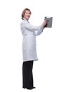 Female doctor smiling and showing a clipboard with an empty document Royalty Free Stock Photo