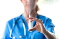Female doctor with a spray or nasal drops for the treatment of a runny nose over white background Royalty Free Stock Photo