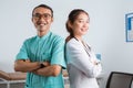 a female doctor standing back to back with the male nurse Royalty Free Stock Photo