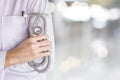 female doctor standing over blur background of hospital  hand holding stethoscope Royalty Free Stock Photo