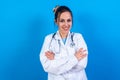 Female doctor stands confidently with her arms folded, looking directly at the camera Royalty Free Stock Photo