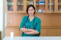 Female doctor stands at hospital. Healthcare worker. woman pharmacist with and stethoscope smiling satisfied with her job in hospi Royalty Free Stock Photo