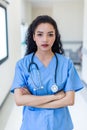 Female doctor stands at hospital. Healthcare worker. woman pharmacist with and stethoscope smiling satisfied with her job in hospi Royalty Free Stock Photo