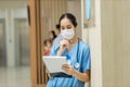 Female doctor stands at hospital. Healthcare worker. woman pharmacist with and stethoscope smiling satisfied with her job in hospi Royalty Free Stock Photo