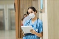 Female doctor stands at hospital. Healthcare worker. woman pharmacist with and stethoscope smiling satisfied with her job in hospi Royalty Free Stock Photo