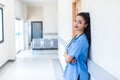 Female doctor stands at hospital. Healthcare worker. woman pharmacist with and stethoscope smiling satisfied with her job in hospi Royalty Free Stock Photo