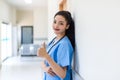 Female doctor stands at hospital. Healthcare worker. woman pharmacist with and stethoscope smiling satisfied with her job in hospi Royalty Free Stock Photo