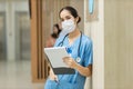 Female doctor stands at hospital. Healthcare worker. woman pharmacist with and stethoscope smiling satisfied with her job in hospi Royalty Free Stock Photo