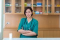 Female doctor stands at hospital. Healthcare worker. woman pharmacist with and stethoscope smiling satisfied with her job in hospi Royalty Free Stock Photo