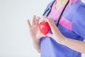 Female doctor with stethoscope holding red heart, isolated on white background, heart healthy care concept with copy space. Royalty Free Stock Photo