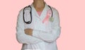 Female doctor with stethoscope and pink ribbon, isolated, Health care, medical breast cancer awareness concept Royalty Free Stock Photo