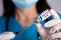 Female doctor with a stethoscope on shoulder holding syringe and COVID-19 vaccine. Healthcare And Medical concept Royalty Free Stock Photo