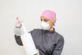 Female doctor in surgical gown using disposable disinfectant wipes Royalty Free Stock Photo