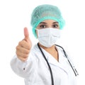 Female doctor with a surgical mask with thumb up