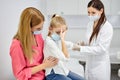 female doctor taking blood sample test of a little girl in the clinic Royalty Free Stock Photo