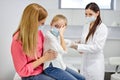 young doctor taking blood sample test of a little girl in the clinic Royalty Free Stock Photo