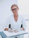 Female doctor taking notes while sitting at the table. Royalty Free Stock Photo