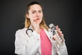 Female doctor taking pill with bottle of water Royalty Free Stock Photo