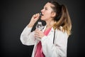 Female doctor taking pill with bottle of water Royalty Free Stock Photo