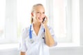 Female doctor talking on the cell phone Royalty Free Stock Photo