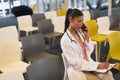 Female doctor talking on mobile phone while writing on a clipboard Royalty Free Stock Photo