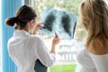 Female doctor talking patient about analyzing x-ray chest scan Royalty Free Stock Photo