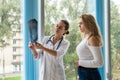 Female doctor talking patient about analyzing x-ray chest scan Royalty Free Stock Photo